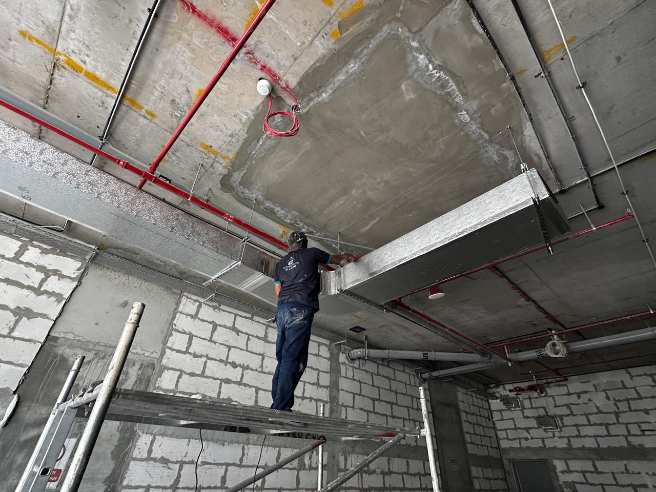 Rapid Home technician installing commercial ductwork