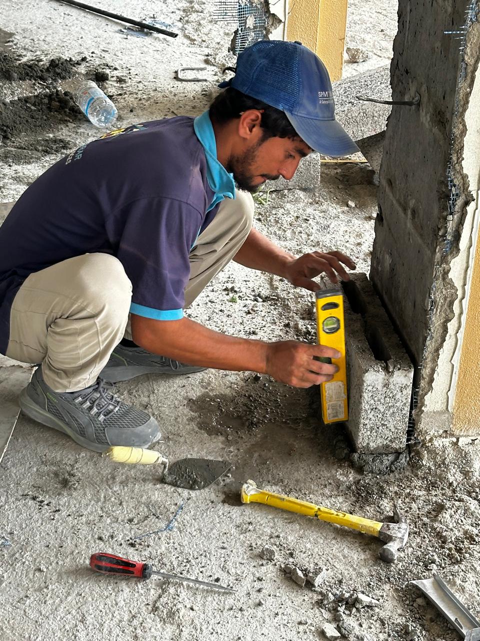 Rapid Home mason checking blockwork level in Dubai