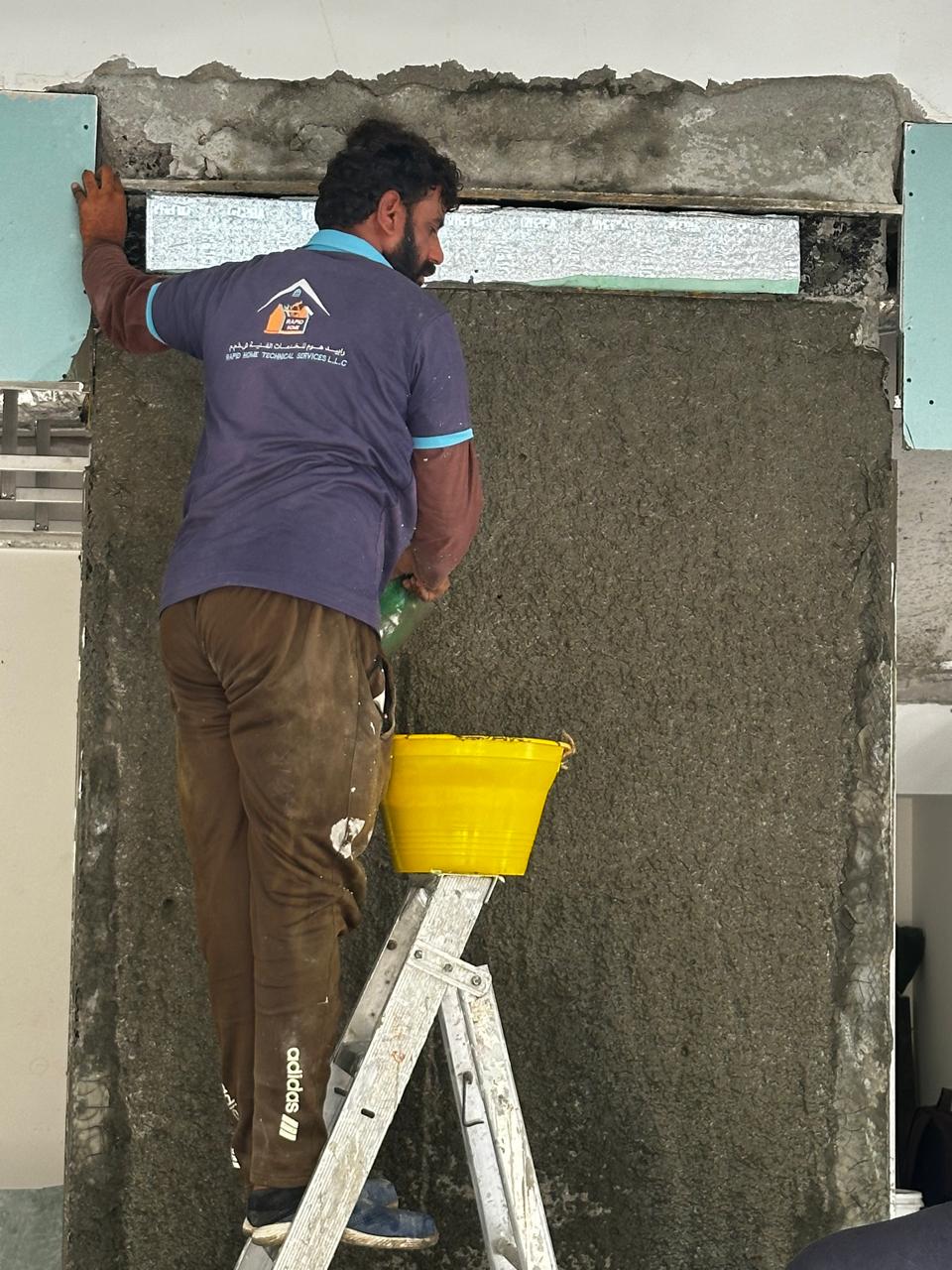 Rapid Home mason applying plaster around a wall opening