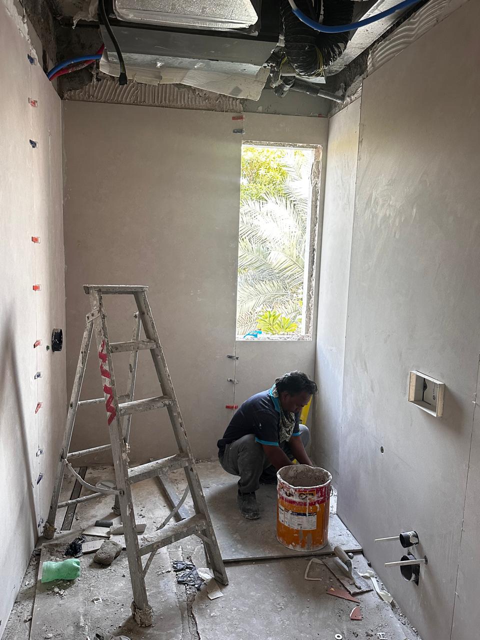 Rapid Home technician installing bathroom wall tiles